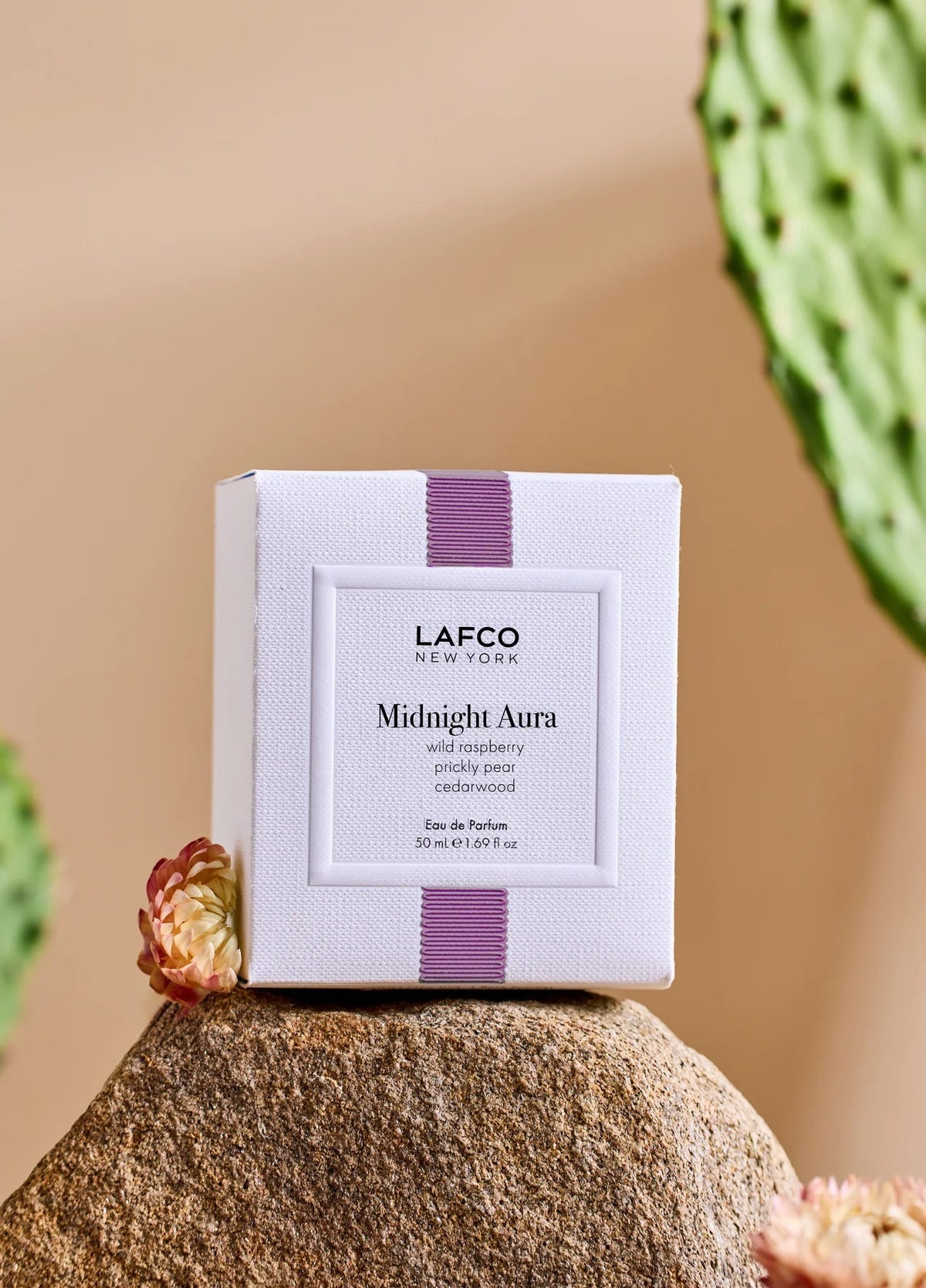 A clear, oval-shaped bottle of LAFCO - FINE FRAGRANCE, MIDNIGHT AURA 50ML, labeled with the LAFCO brand, crafted as a vegan perfume with essential oils and topped with a light pink marbled cap, displayed on a white background.