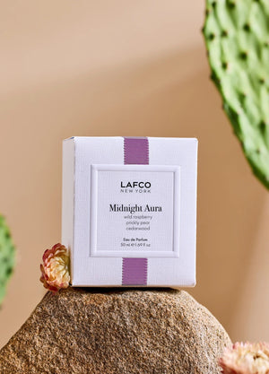A clear, oval-shaped bottle of LAFCO - FINE FRAGRANCE, MIDNIGHT AURA 50ML, labeled with the LAFCO brand, crafted as a vegan perfume with essential oils and topped with a light pink marbled cap, displayed on a white background.