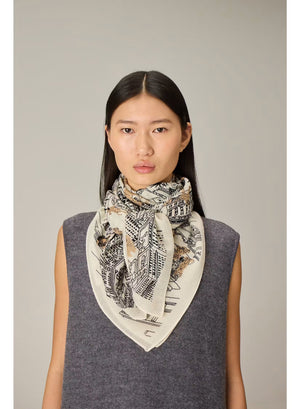An intricately illustrated map of Central Park, New York, featuring surrounding buildings, trees, and warmly dressed people wrapped in cozy scarves—many reminiscent of the INOUI EDITIONS - CENTRAL PARK WOOL SCARF IN BEIGE by INOUI—comes alive with handwritten labels and a sepia-toned palette. Inspired by the inviting warmth and comfort of this 100% wool scarf made in India, the artwork beautifully evokes the iconic cityscape’s welcoming atmosphere.