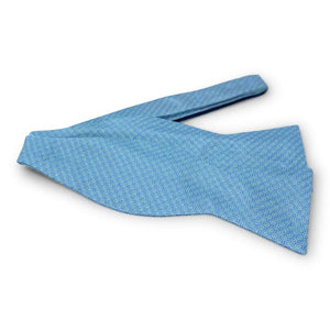 The BIRD DOG BAY PETER-BLAIR Floyd Silk Bow Tie in Green features a handmade design with a subtle repeating geometric pattern, showcased against a plain white background.