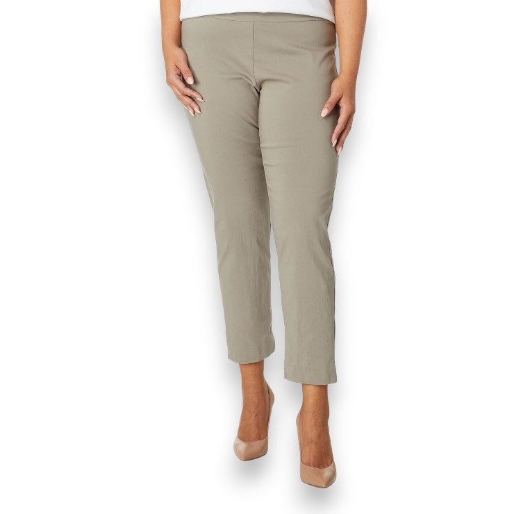 A person is wearing KRAZY LARRY, INC&#39;s PULL ON ANKLE PANT in a slim fit beige straight-leg style and black high-heeled shoes against a white background. The outfit is completed with a sleeveless black top that reveals part of the arms and torso.