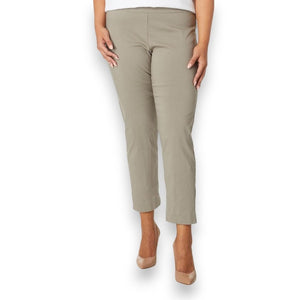 A person is wearing KRAZY LARRY, INC's PULL ON ANKLE PANT in a slim fit beige straight-leg style and black high-heeled shoes against a white background. The outfit is completed with a sleeveless black top that reveals part of the arms and torso.