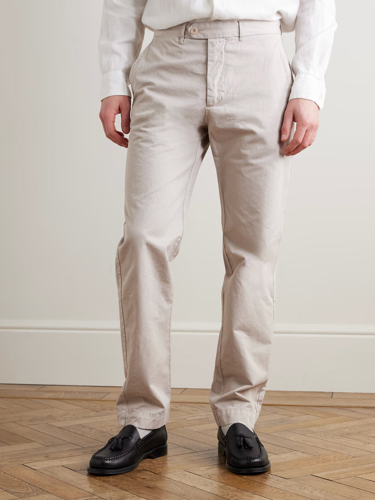 A close-up of the HARTFORD - TAYLOR PANTS IN STONE shows a buttoned back pocket, belt loop, and visible stitching on the waistband of these straight-leg men's pants.
