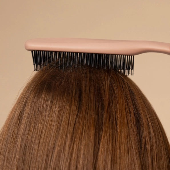 A KITSCH - Scalp Renewal Brush in Terracotta is displayed beside its box packaging, which features the product name and emphasizes its gentle, soothing scalp massage benefits as well as its eco-friendly materials. This nylon bristle brush by KITSCH is ideal for refreshing your scalp and effortlessly promoting healthy hair.