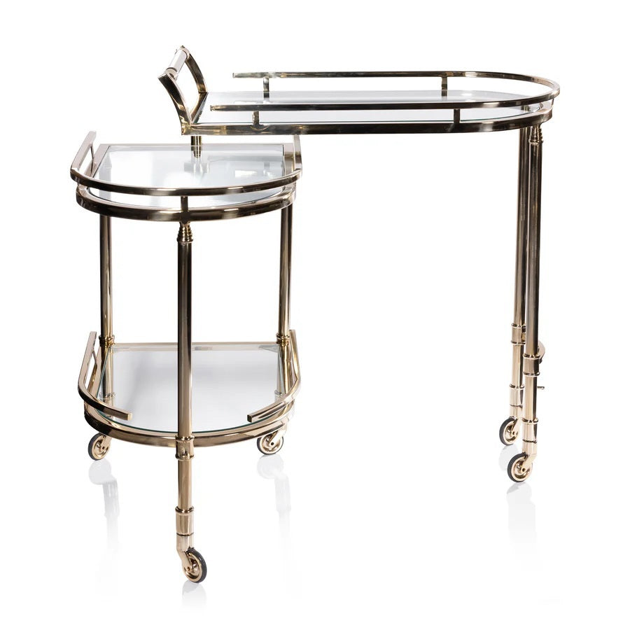 The SPIGA GOLD BAR CART by ZODAX features a vintage Italian-inspired design with elegant gold framing, mirrored glass shelves on both tiers, and smooth-rolling four-wheel mobility. Displayed against a white background, this piece is both stylish and functional.