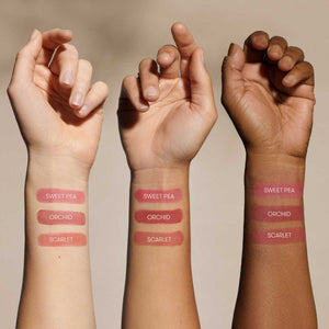 A single swatch of MINORI - CREAM BLUSH in Scarlet sweeps across a white background, revealing its creamy texture and rich pigment—capturing the effortless glow of a natural-looking blush from MINORI.