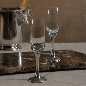 The ZODAX ST. MORITZ Pewter and Glass Champagne Flute features a clear bowl with a silver-tone metal stem and base, photographed on white, and is ideal for serving sparkling wine from 210 ml bottles or other small containers.