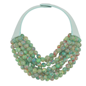 The FAIRCHILD BALDWIN - THE BELLA NECKLACE showcases layered strands of iridescent green Italian resin beads with a faceted design for a shimmering effect, finished with a smooth light green clasp that complements its vibrant hues.