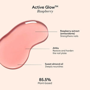 A pink serum drop labeled with its ingredients: raspberry extract (strengthens nails), AHAs (restore and harden), and sweet almond oil (nourishes). The text highlights that MANUCURIST - ACTIVE GLOW CARE POLISH by MANUCURIST INC is 85.5% plant-based—making it the ideal nail strengthener for achieving healthy, glass-like nails.