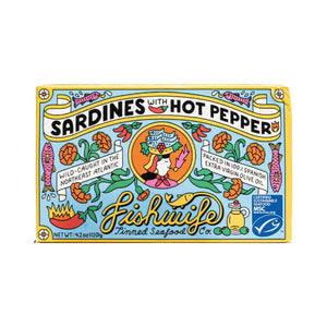 A vibrant tin of FISHWIFE SARDINES & HOT PEPPER features lively fish, peppers, flowers, and olive oil illustrations. The label highlights FISHWIFE’s sustainably caught sardines in Spanish extra virgin olive oil.