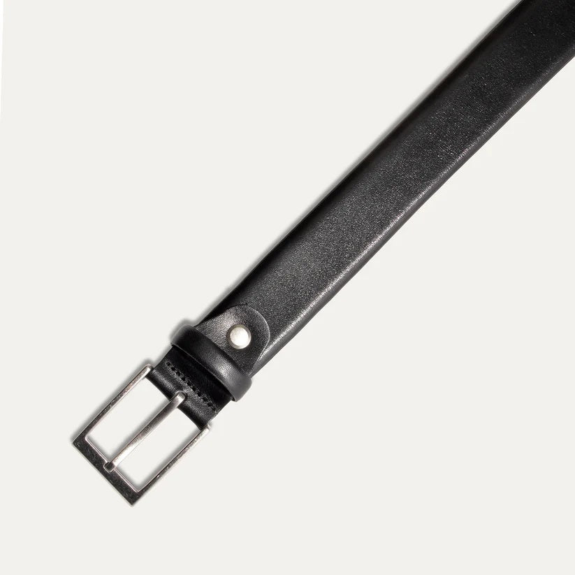 A close-up of the WILL LEATHER GOODS - GLAZED CALFSKIN BELT IN BLACK showcases its black glazed calfskin and five adjustment holes, set against a white background.