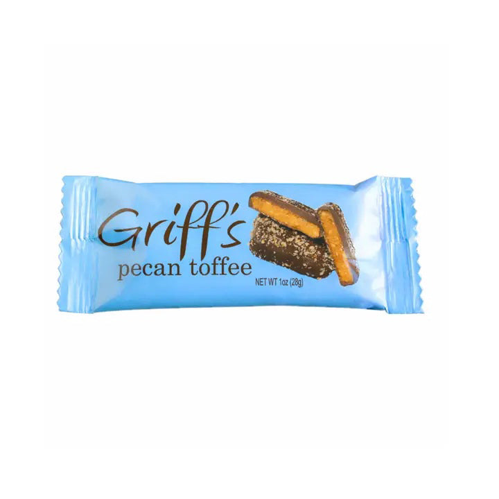 A blue wrapper labeled "GRIFF'S TOFFEE - COFFEE 1OZ" from GRIFFS TOFFEE features rectangular, gluten free coffee toffee pieces coated in dark chocolate and pecans. Net weight 1 oz (28g) appears below the product name.