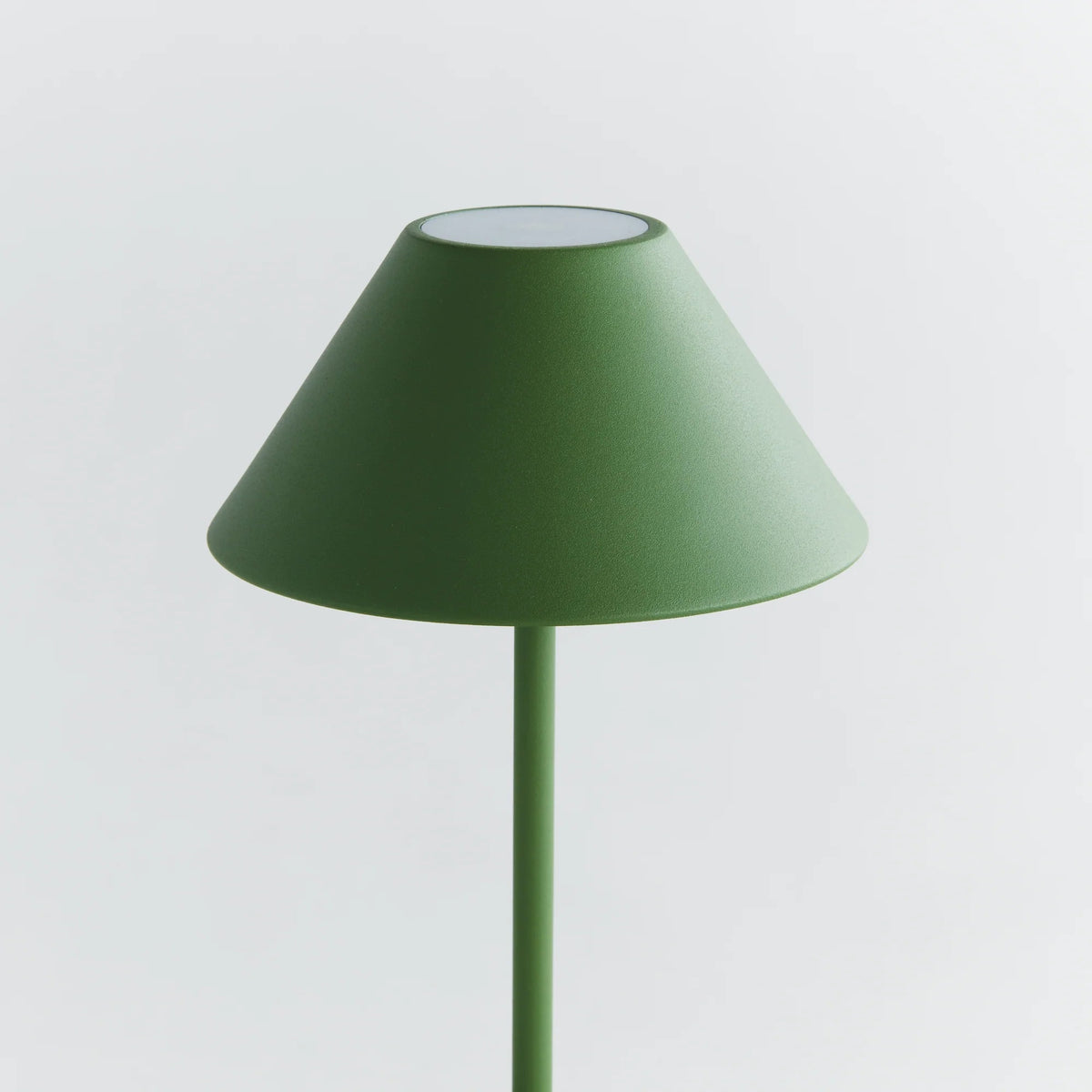 The NAPA HOME AND GARDEN - ALLUNA 10” Cordless LED Lamp in green, a compact and modern luxury table lamp featuring a metal conical shade and a round base, is displayed against a plain white background.
