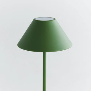 The NAPA HOME AND GARDEN - ALLUNA 10” Cordless LED Lamp in green, a compact and modern luxury table lamp featuring a metal conical shade and a round base, is displayed against a plain white background.