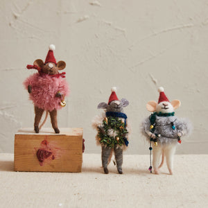 The CREATIVE COOP HANDMADE FELT MOUSE WITH FAUX FUR SWEATER wears a Santa hat and scarf; each mouse features unique holiday details like a wreath, bell, or string lights and makes a charming festive ornament.