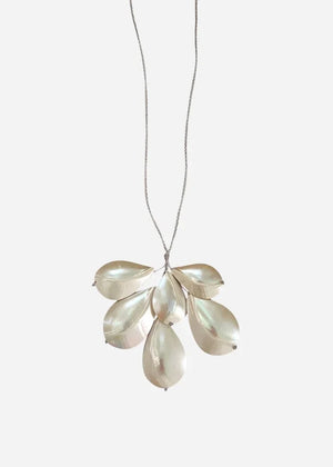 The ANN LIGHTFOOT - CHAMBERED NAUTILUS SHELL SPRAY NECKLACE by ANN LIGHTFOOT is showcased on a white jewelry bust against a plain white background. Reminiscent of an elegant spray necklace, this piece features overlapping metallic chambered nautilus shell pendants suspended from an adjustable sleek black nylon cord.