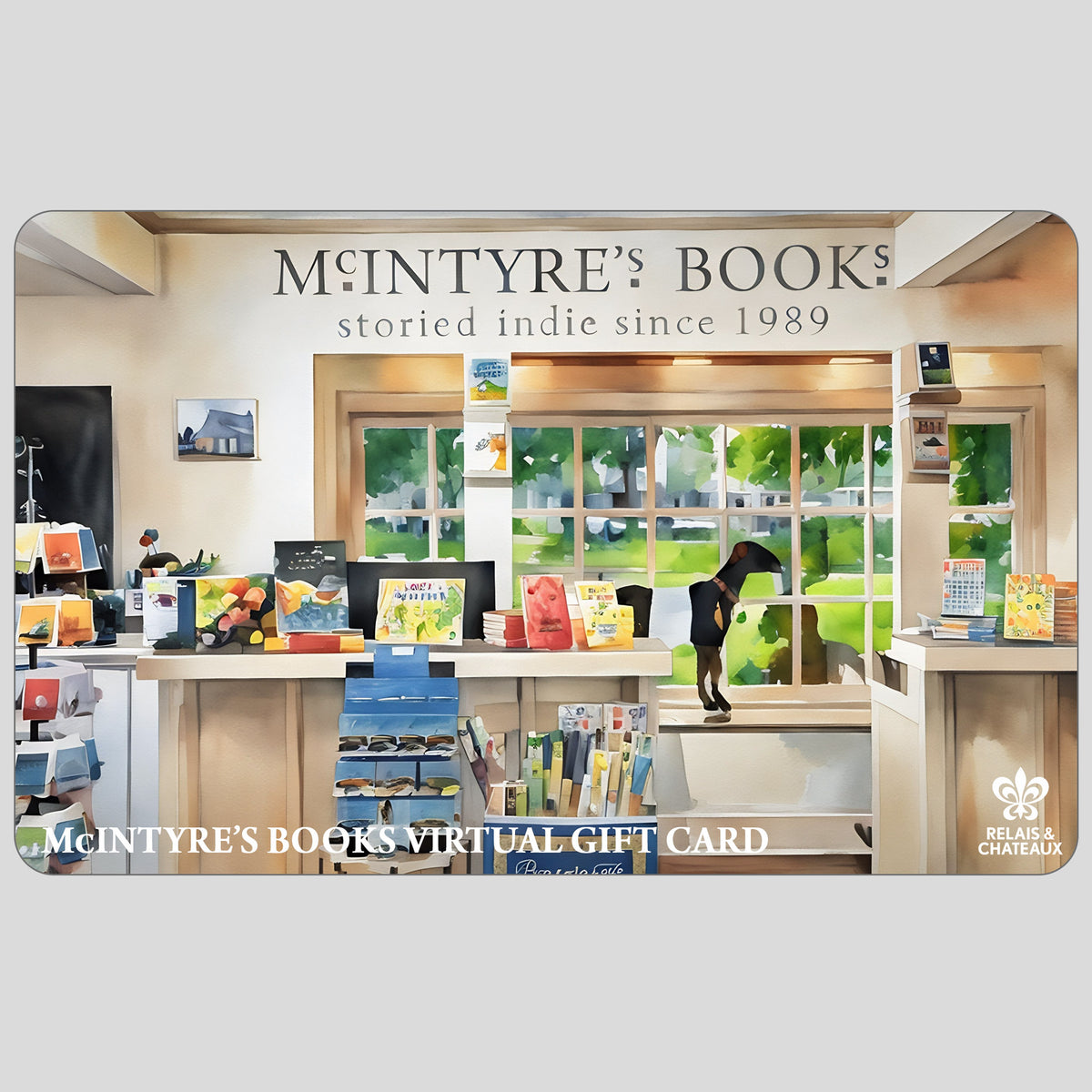 A bright, spacious bookstore with wooden floors, shelves of books and cards, and a sign reading &quot;MCINTYRE&#39;S BOOKS VIRTUAL E-GIFT CARD&quot;—the perfect last minute gift from FEARRINGTON VILLAGE. The Relais &amp; Châteaux logo is in the corner.