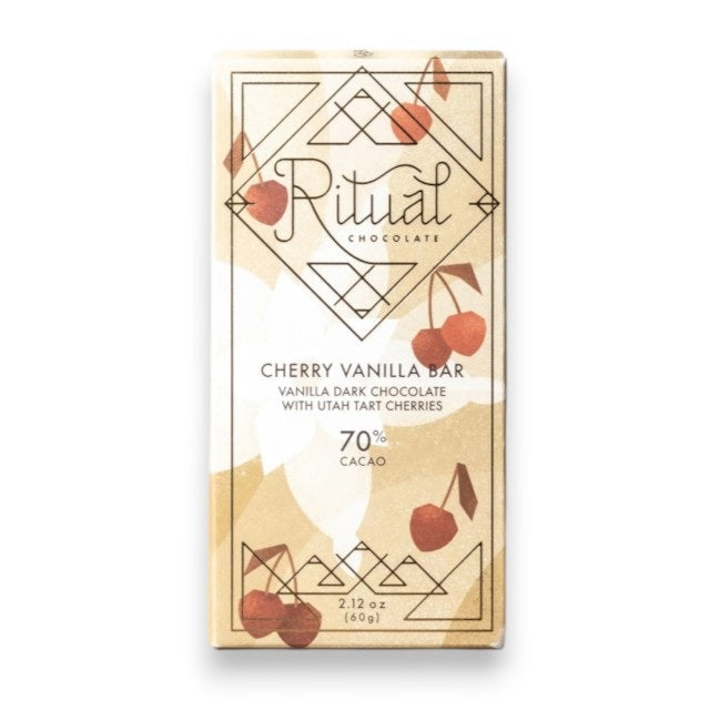 A beige RITUAL CHOCOLATE - VANILLA CHOCOLATE CHERRIES bar wrapper featuring geometric patterns, red Montmorency cherries, and text that reads “Cherry Vanilla Bar, Vanilla Dark Chocolate with Utah Tart Cherries, 70% Cacao, 2.12 oz (60g),” by RITUAL CHOCOLATE.