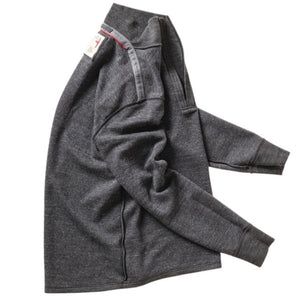 The RELWEN Wool and Cotton Quarter Zip in Charcoal Heather is laid flat on a white background, featuring long sleeves slightly bent at the sides and a collar partially unzipped.