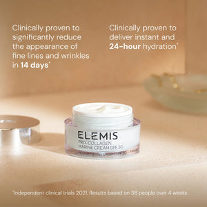 An open jar of ELEMIS - PRO-COLLAGEN MARINE CREAM SPF30 100ML by ELEMIS - STEINER sits on a bathroom counter, with text highlighting its anti-aging and hydrating benefits, and clinical trial results displayed at the bottom.