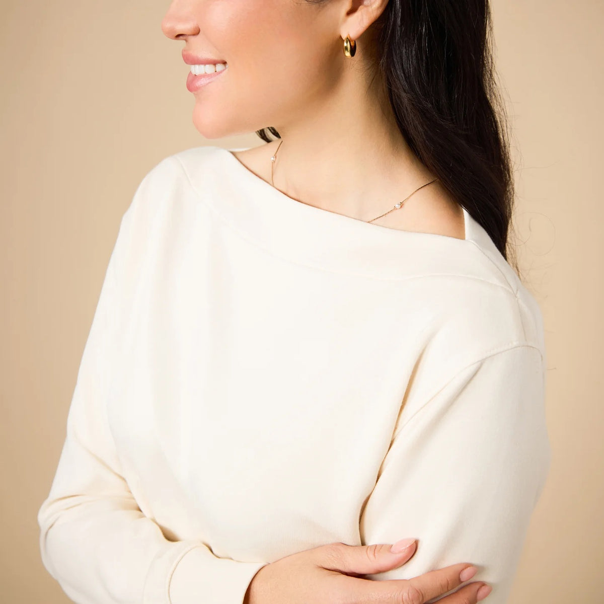 A woman wears a SOFTIES - DREAMTECH BOAT NECK WITH PINTUCK PANT SET in olive green, featuring a long-sleeve boat neck top and matching wide-leg pintuck pants.