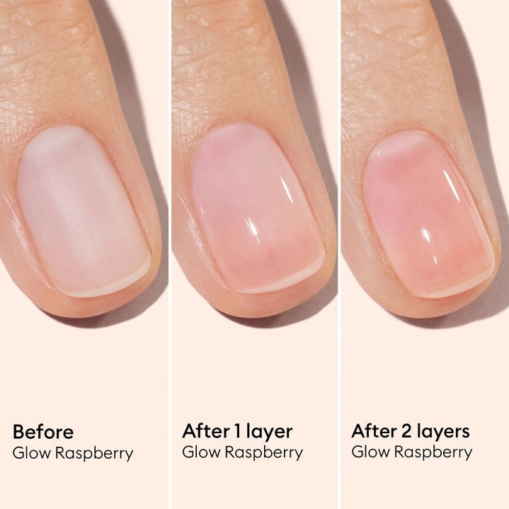 A pink serum drop labeled with its ingredients: raspberry extract (strengthens nails), AHAs (restore and harden), and sweet almond oil (nourishes). The text highlights that MANUCURIST - ACTIVE GLOW CARE POLISH by MANUCURIST INC is 85.5% plant-based—making it the ideal nail strengthener for achieving healthy, glass-like nails.