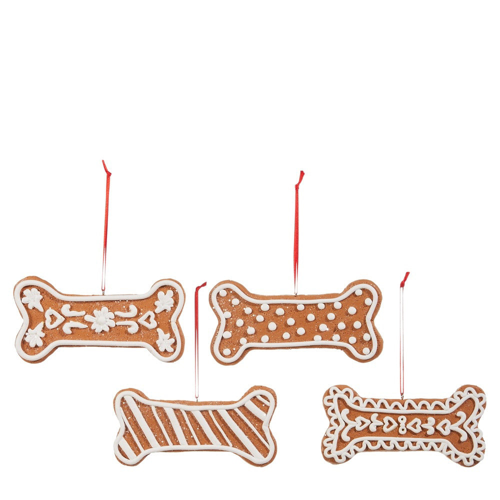 The GINGERBREAD DOG BONE ORNAMENT by RAZ IMPORTS features four handmade clay dough ornaments, each with white icing designs and red strings in assorted styles—flowers, polka dots, stripes, and hearts.
