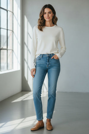 A plain, long-sleeve, white crew-neck T-shirt from SEVENTY displayed against a light background. The fabric appears smooth and the shirt has a relaxed fit. A black garment tag at the collar indicates that it's made in Italy.