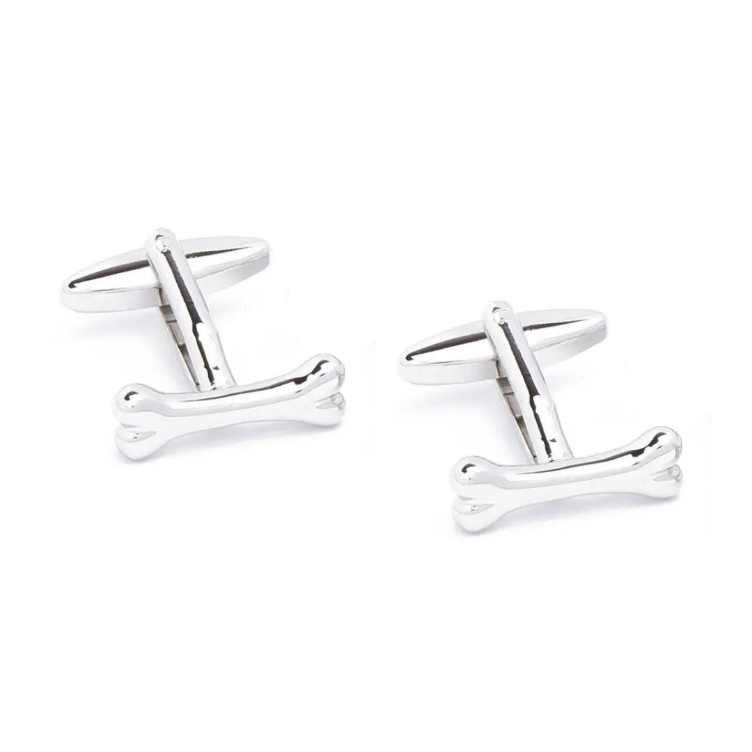 STOLEN RICHES - BONE CUFFLINKS: Stylish silver cufflinks by STOLEN RICHES, uniquely crafted in bone shapes and shown on a white background—an eye-catching twist for men’s accessories.