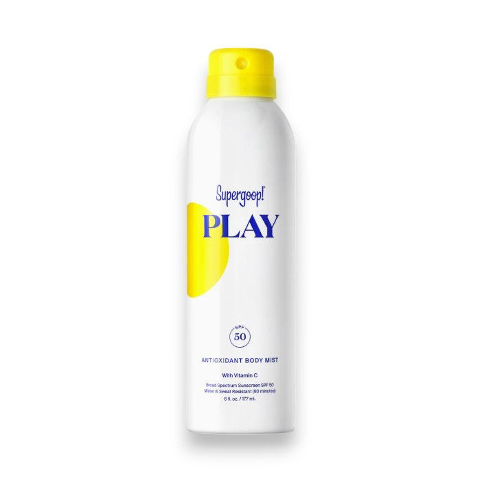 A bottle of SUPERGOOP - PLAY ANTIOXIDANT MIST SPF 50 WITH VITAMIN C ensures glowing skin. The predominantly white sunscreen body spray has yellow and blue accents, featuring a yellow sun graphic on the left side. It offers broad-spectrum protection, Vitamin C, is water-resistant, and weighs 6 oz (177 mL).