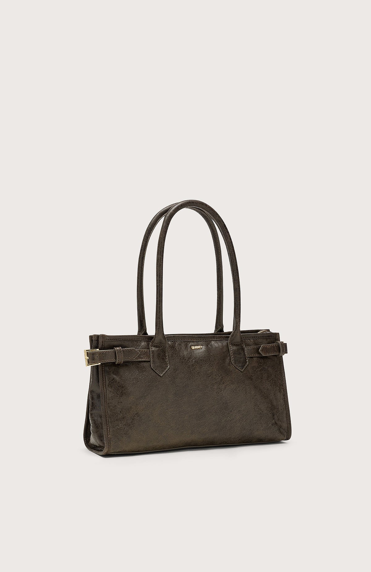 The SEVENTY VENEZIA Leather Handbag by SEVENTY is dark brown Italian leather, rectangular, with double handles, small side buckles, and a subtle front metallic logo, shown on a plain light background.