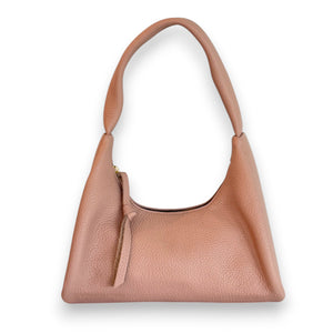 The OLIVEVE Gia Baguette Handbag in nude Italian buffalo cowhide features a pebbled texture and curved handle. It's ethically made with a zipper closure, leather pull tab, and set against a white background.