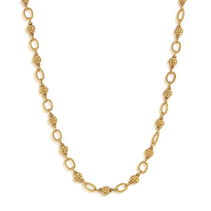 The CAPUCINE DE WULF Berry and Bead Chain Necklace features alternating textured and smooth oval links with ornate bead details, crafted in 18K gold and finished with an anti-tarnish coating, shown on a white background.
