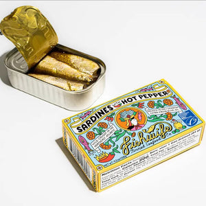 A vibrant tin of FISHWIFE SARDINES & HOT PEPPER features lively fish, peppers, flowers, and olive oil illustrations. The label highlights FISHWIFE’s sustainably caught sardines in Spanish extra virgin olive oil.