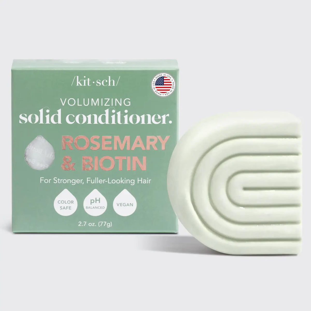 The image shows a box and curved light green bar of KITSCH's color-safe, pH-balanced, vegan Volumizing Solid Conditioner with rosemary and biotin, labeled "Kitsch Rosemary and Bioton Volumizing Solid Conditioner.