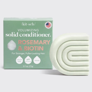 The image shows a box and curved light green bar of KITSCH's color-safe, pH-balanced, vegan Volumizing Solid Conditioner with rosemary and biotin, labeled "Kitsch Rosemary and Bioton Volumizing Solid Conditioner.