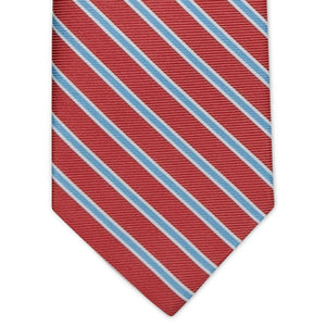 The COLLARED GREENS - WHITMAN TIE IN CORAL AND LIGHT BLUE by BIRD DOG BAY is a rolled-up coral necktie featuring diagonal light blue and white stripes, displayed on a white background. Crafted from premium materials, this versatile striped tie elevates any outfit with a touch of sophistication.