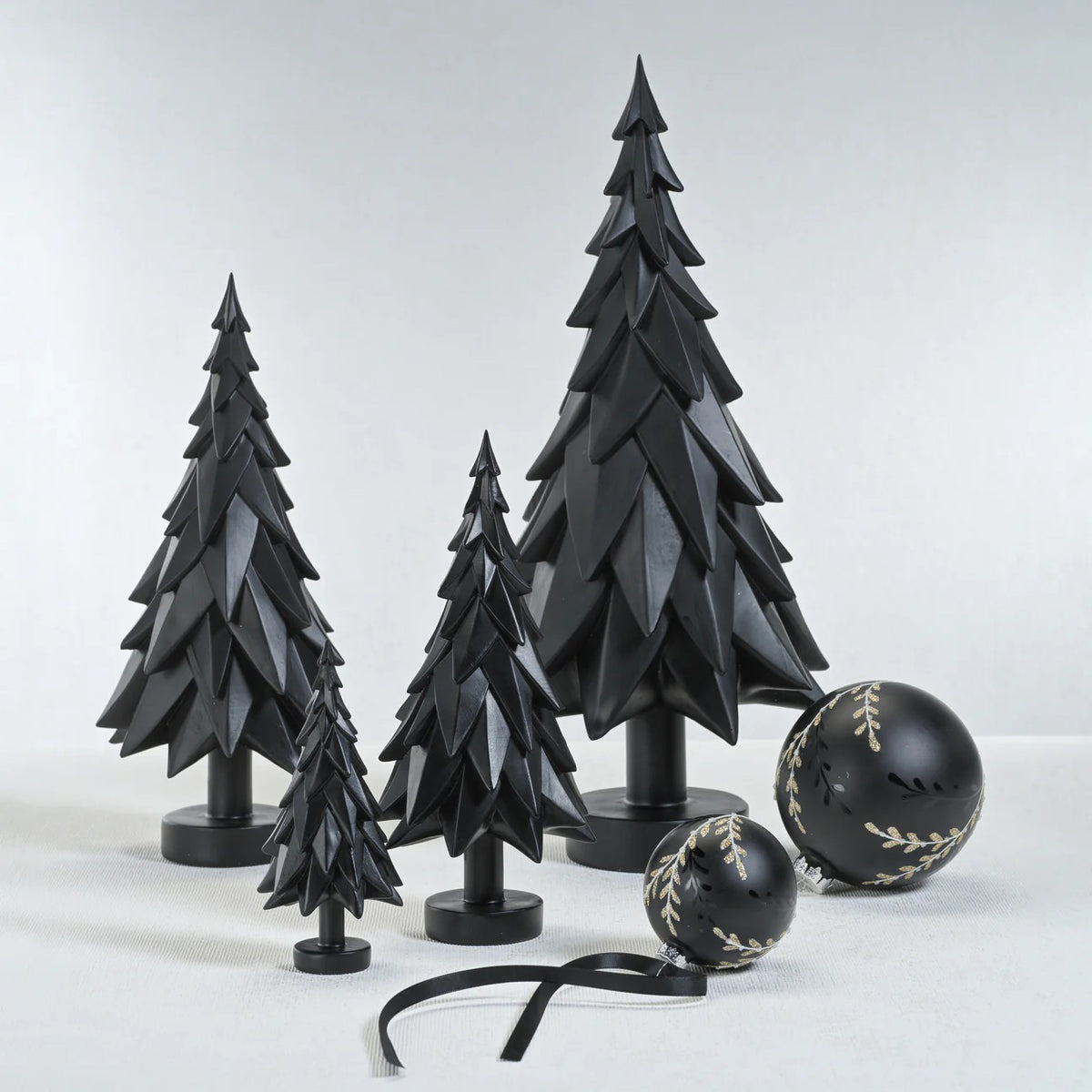 The ZODAX BLACK MATTE DECORATIVE TREE - MEDIUM is a modern resin figurine featuring angular, layered branches and a round base, perfect for stylish home decor.