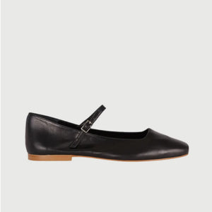 The AUGUSTA - JULIETA MARY JANE by AUGUSTA is a black leather flat shoe featuring a slender, adjustable strap across the top and a low wooden heel. With its renewed silhouette, slightly pointed toe, and minimalist design, this handcrafted Spanish shoe is presented against a plain, light gray background.