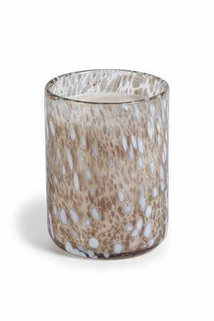 SPECKLED LUMINA TONKA ABSOLUTE SCENTED CANDLE 21.5OZ cylindrical glass candle holder featuring a brown and white speckled pattern.