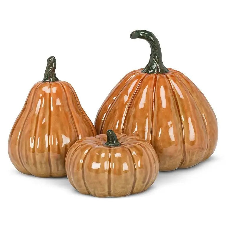 Three glazed ceramic pumpkins of varying shapes and sizes with dark green stems, including one TALL CERAMIC PUMPKIN by ABBOTT.