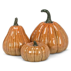 Three glazed ceramic pumpkins of varying shapes and sizes with dark green stems, including one TALL CERAMIC PUMPKIN by ABBOTT.