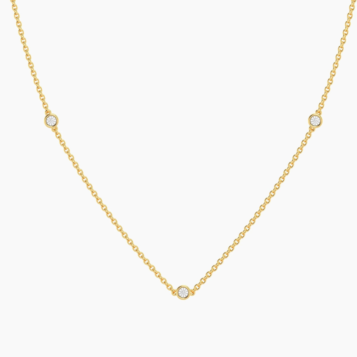 The ELLA STEIN - DOT TO DOT NECKLACE by ELLA STEIN is a delicate gold plated piece featuring a fine chain adorned with three evenly spaced small round natural diamonds, beautifully showcased on a white background. This elegant necklace brings a touch of sophistication to any outfit.