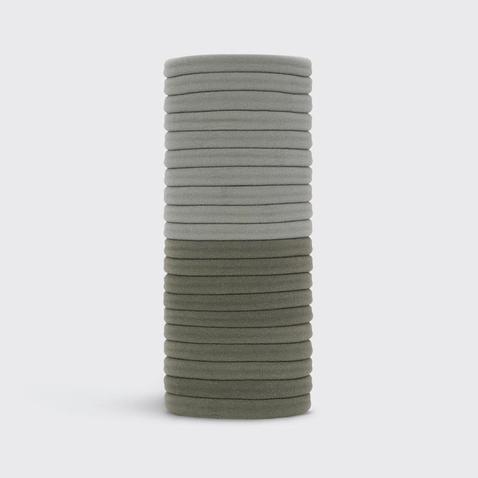 A KITSCH set of 20 eco-friendly nylon elastics in muted green, made from recycled materials. These essential hair ties come packaged under the "KITSCH" brand, displayed on hanging packaging with brand and product details.