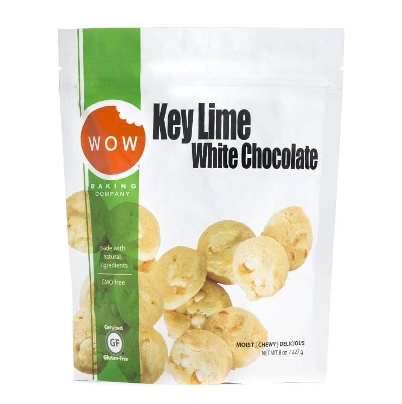 A white stand-up pouch of WOW BAKING - GLUTEN FREE KEY LIME WHITE CHOCOLATE COOKIE POUCH from WOW BAKING COMPANY. The packaging displays images of cookies, a green strip on the left, and product details such as "made with natural ingredients," "GMO-free," and "gluten-free." Net weight: 8 oz.