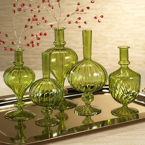 The VENETIAN SPIRAL VASE IN GREEN ONION SHAPE, 9” by ZODAX features a round, ribbed borosilicate glass body in green, a narrow neck, a small round detail at the base, and a flared circular foot—making it an elegant decorative vase.