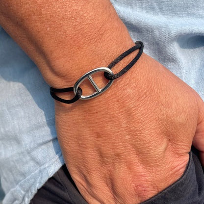 The STOLEN RICHES Viseu String Bracelet features an anchor chain fixture in black, shown on a light background.