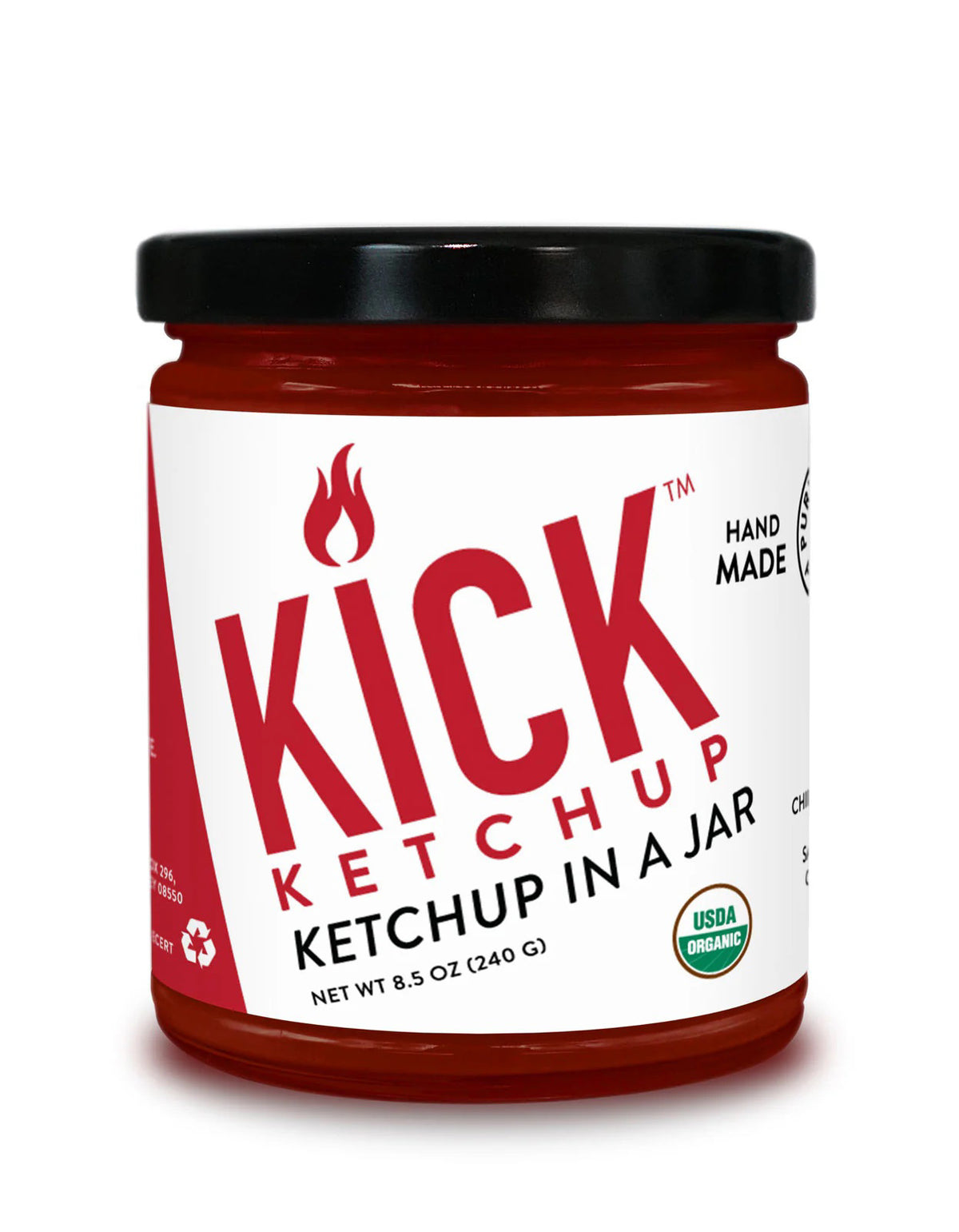 A jar of PURE INDIAN FOODS- KICK KETCHUP by PURE INDIAN FOODS features a black lid, white label with bold red text, flame icon, and &quot;Ketchup in a Jar.&quot; This spicy ketchup is handmade with chipotle morita and is USDA Organic.