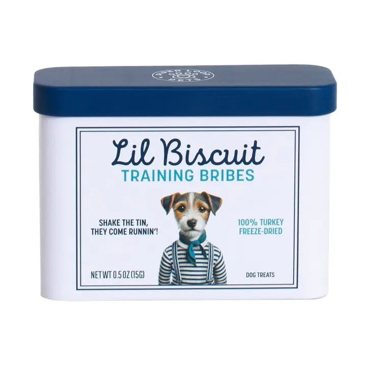 A rectangular tin with a blue lid labeled “PIPER LOOP PETS - LIL BISCUIT TRAINING BRIBES, FREEZE-DRIED TURKEY” features a puppy photo and contains 100% turkey, protein-rich treats for training and emergency recall.