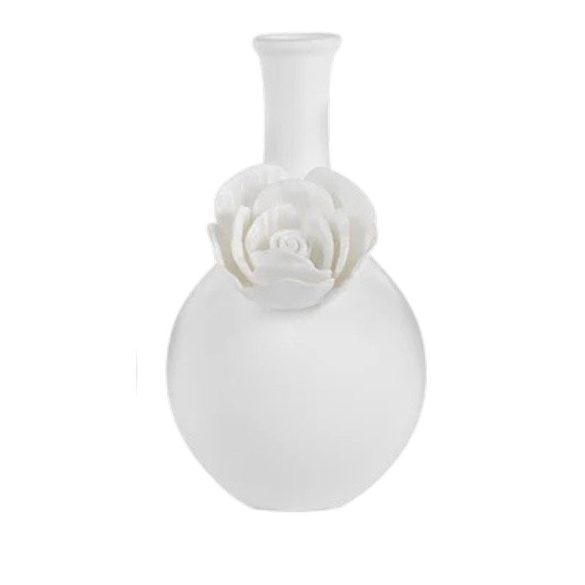 The CAMEO LONG NECK PORCELAIN BUD VASE by ZODAX is a round, white vase with a matte finish, featuring a narrow neck and a detailed floral embellishment on the front.